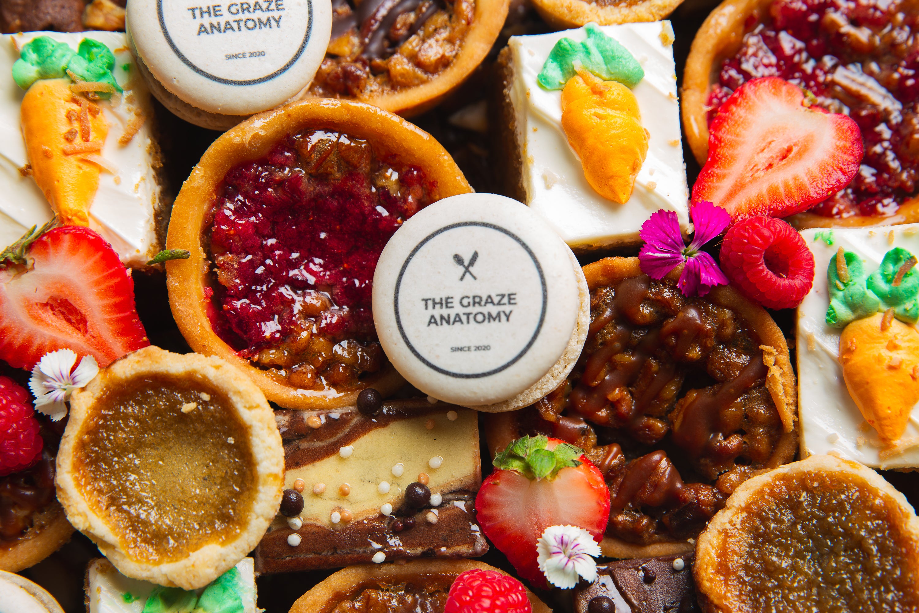 Close up of The Graze Anatomy - Charcuterie Boards Toronto Holiday Dessert Board with butter tarts, carrot cakes, and small cakes