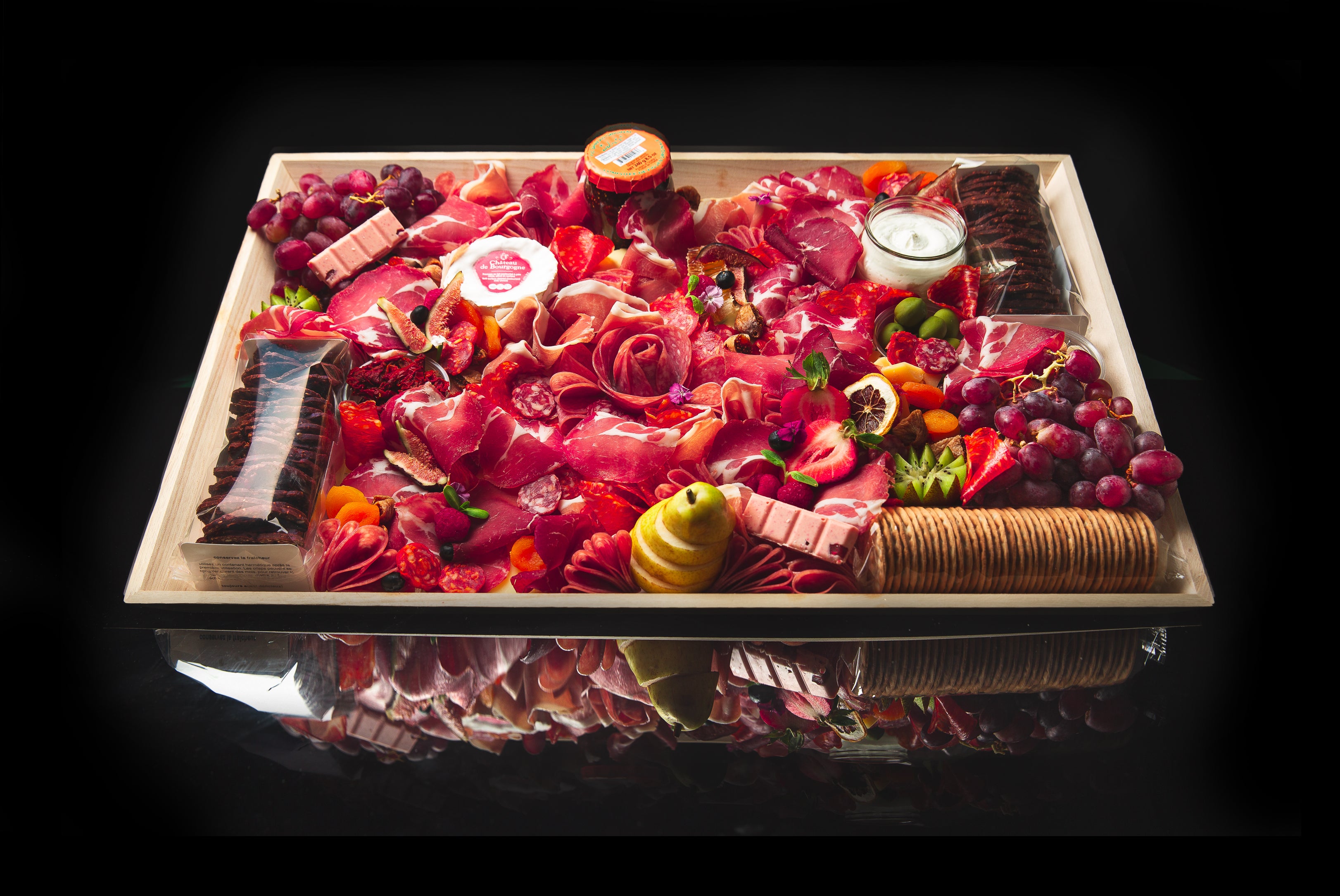 Charcuterie Board Toronto by The Graze Anatomy featuring premium meats, cheeses, and fruits on a dark background
