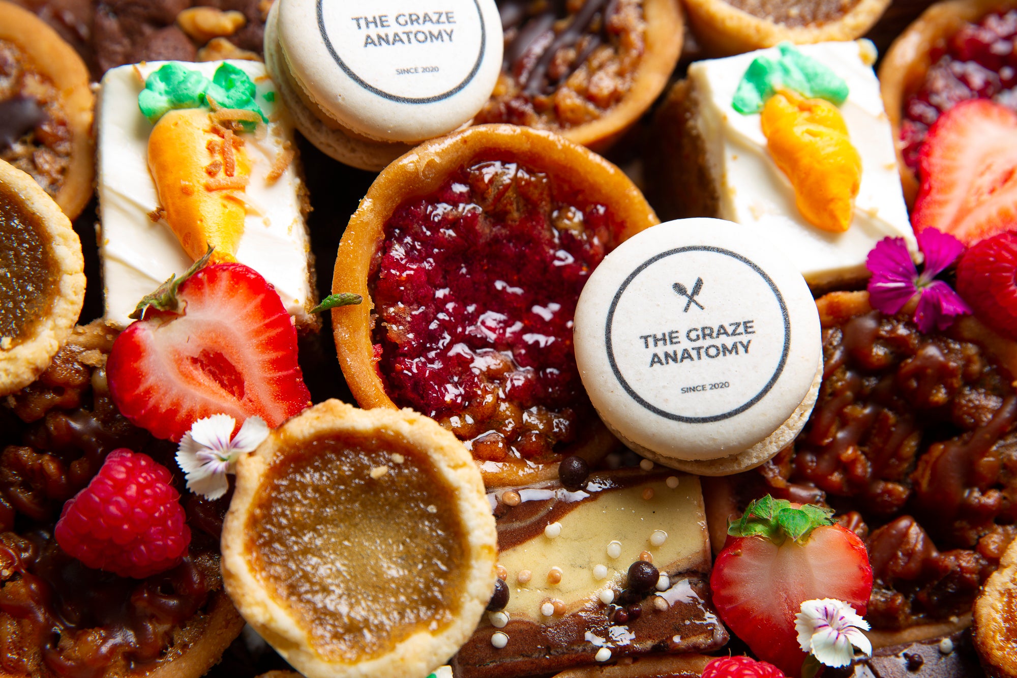 Close up of The Graze Anatomy's Holiday Dessert Platter featuring The Graze Anatomy macaroons, butter tarts, carrot cake, and fresh fruit
