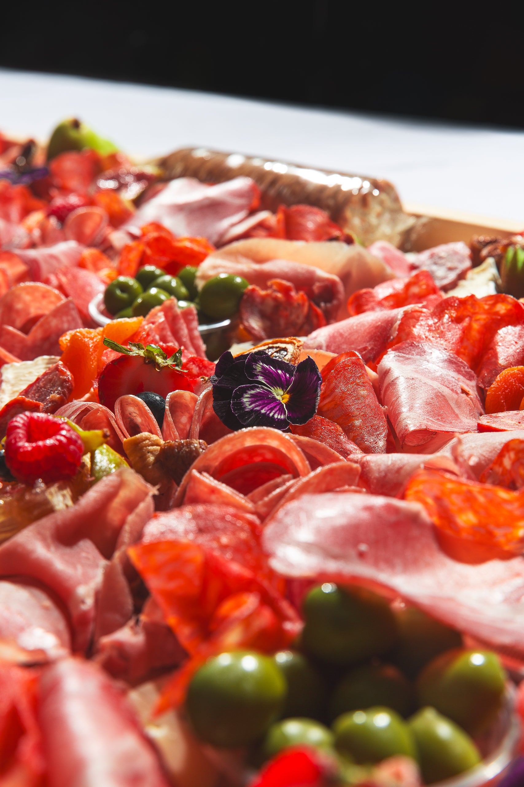 Close-up of edible flowers on charcuterie board for delivery in Toronto