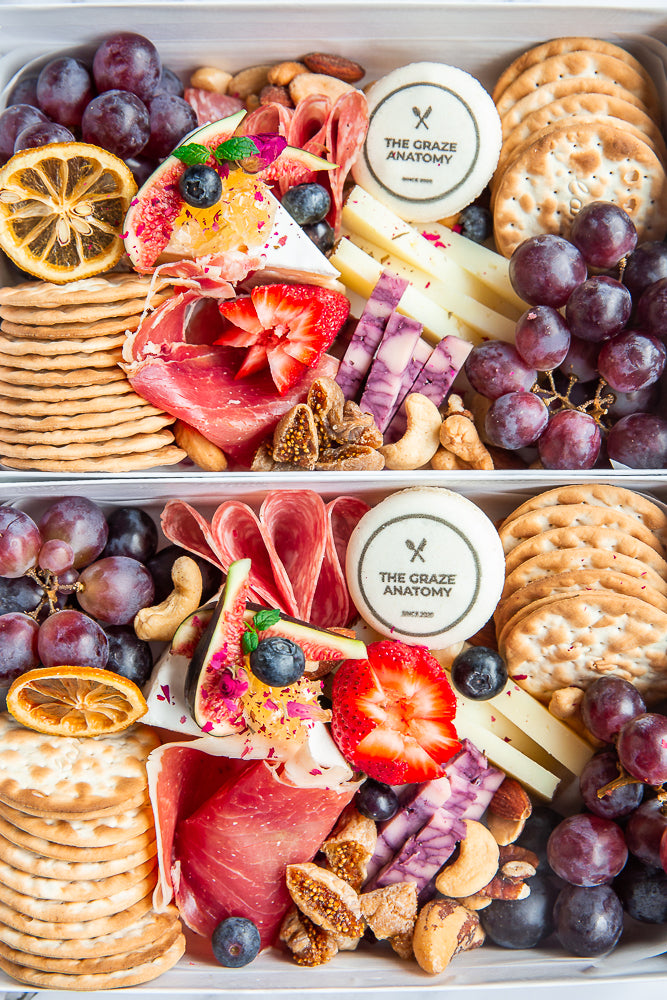 Two Mini Charcuterie Boxes stacked vertically and ready to be delivered. 